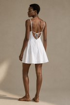 White linen a-line mini dress, back view, slim straps and low back