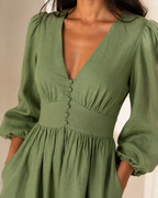 Fern green linen a-line midi dress, close-up of the button placket