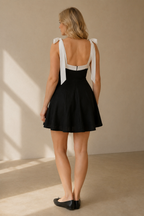 Black linen a-line mini dress, back view, tie shoulder straps and back zipper