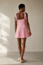 Pink linen a-line mini dress, back view, smooth back and defined waist