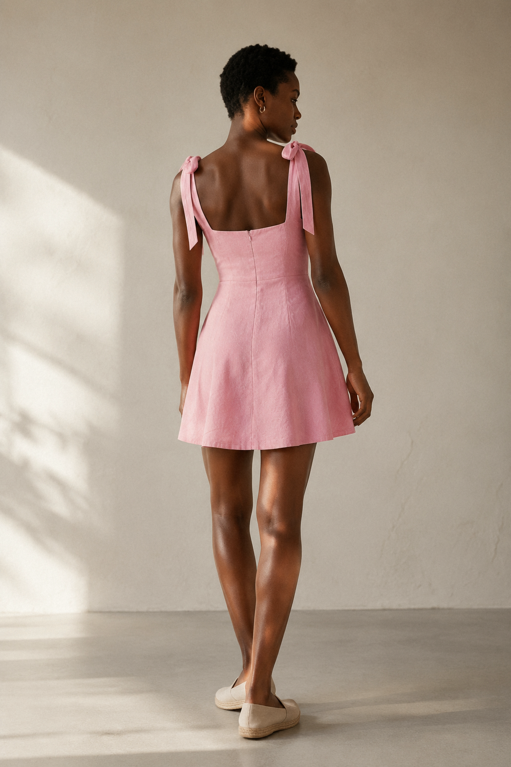 Pink linen a-line mini dress, back view, smooth back and defined waist