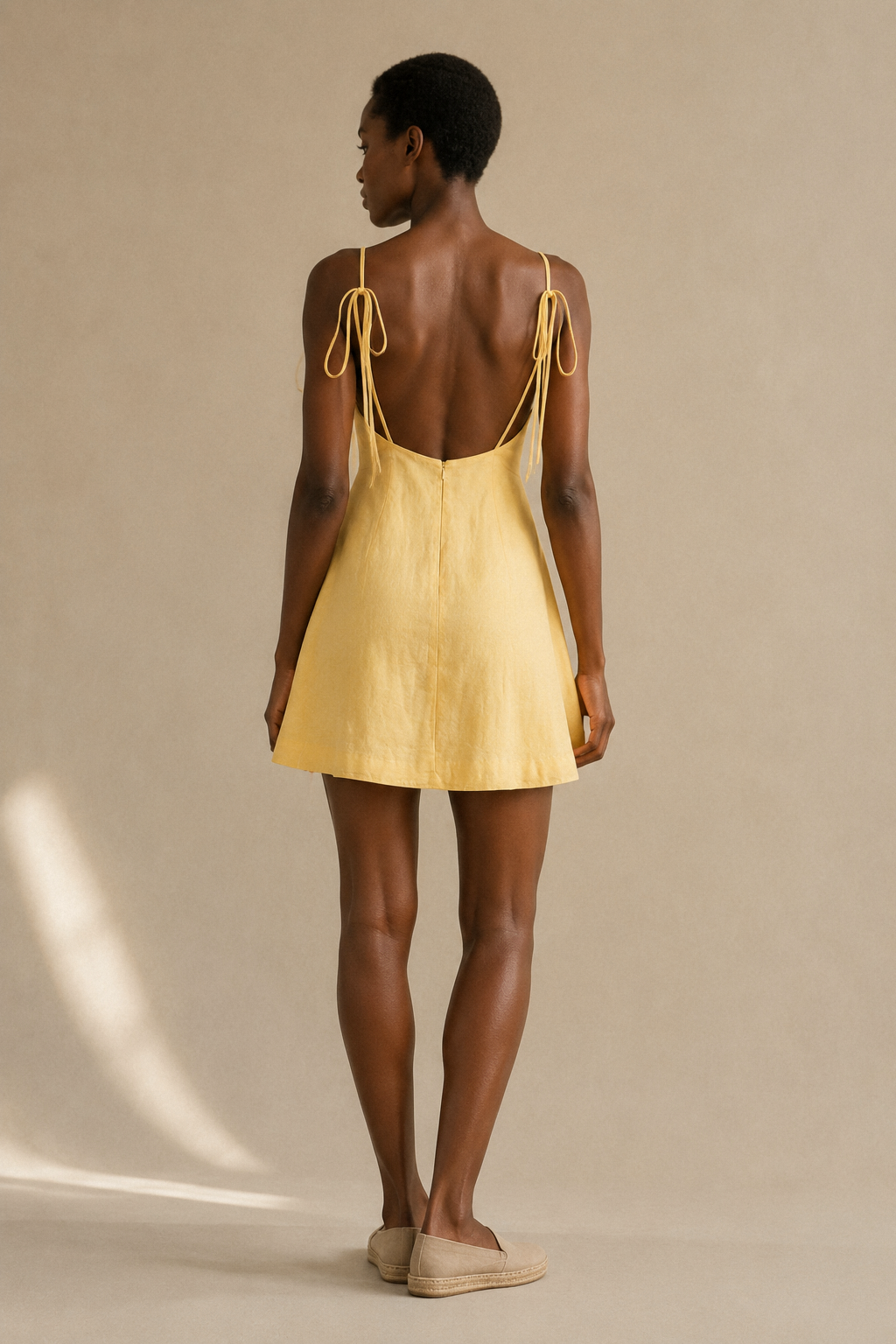 Butter yellow linen a-line mini dress, back view, open back, self-tie straps