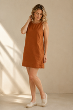 Rust linen shift mini dress, three-quarter view, loose silhouette, fluid drape