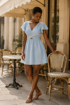 Light blue linen a-line mini dress, front view, v-neck and flutter sleeves with wrap waist
