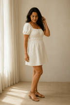 Ivory linen a-line mini dress, three-quarter view, puff sleeves and gathered waist