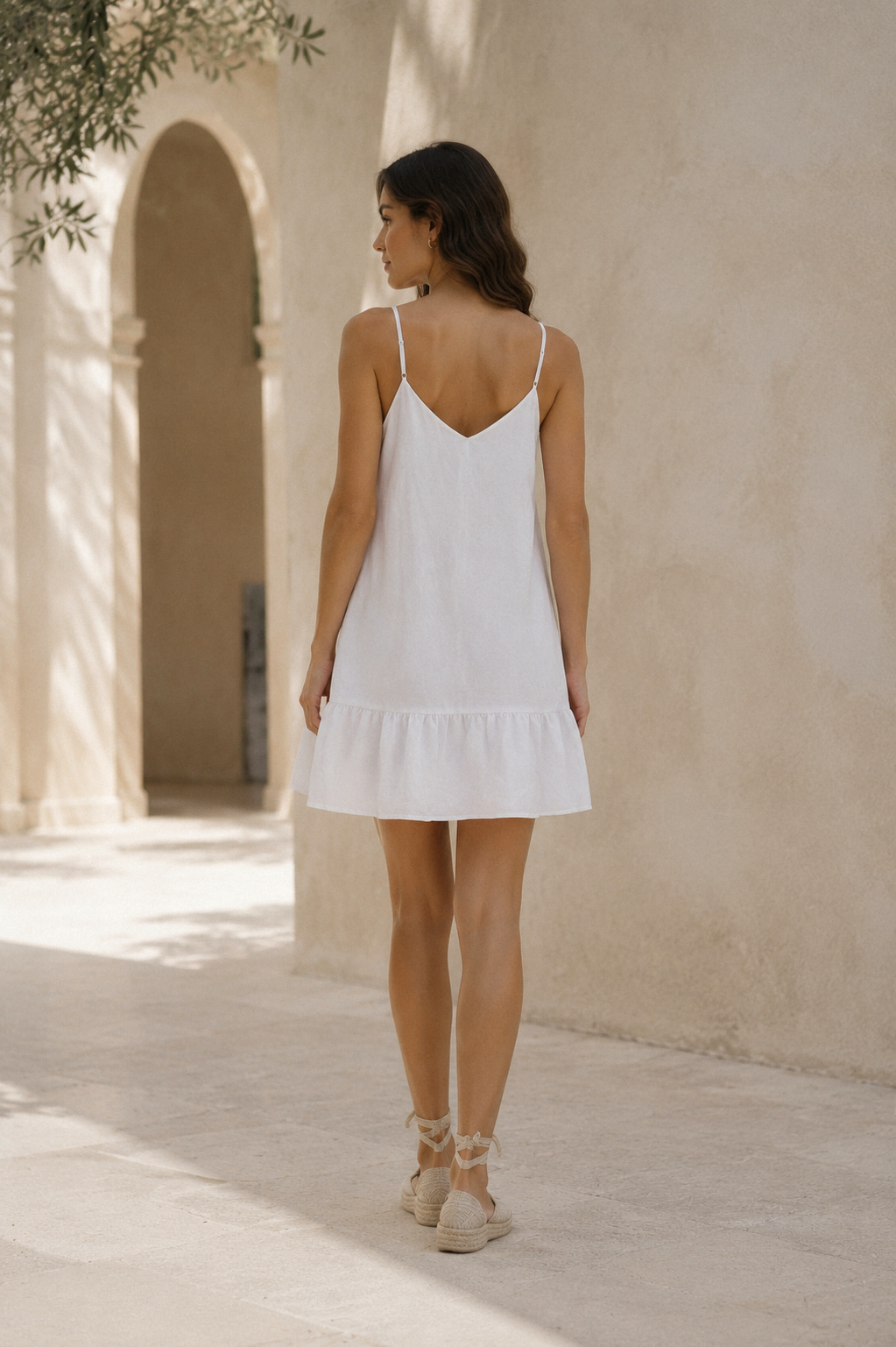 White linen shift mini dress, back view, flowing back, simple construction