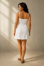 White linen a-line mini dress, back view, spaghetti straps and fitted bodice