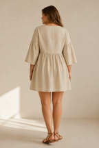 Beige linen a-line mini dress, back view, relaxed fit and gentle drape