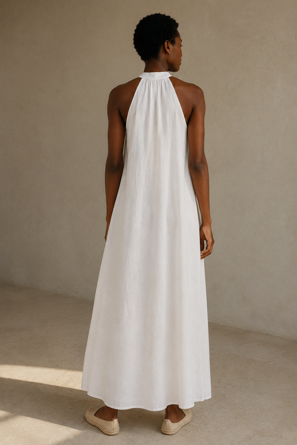 White linen shift mini dress, back view, halter neck with open back