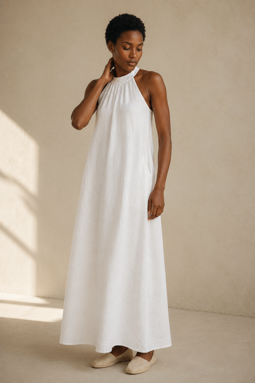 White linen shift mini dress, three-quarter view, side pockets and linen texture