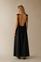 Black linen slip maxi dress, back view, deep scoop back and tie straps