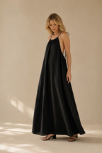 Black linen slip maxi dress, three-quarter view, relaxed fit and shoulder ties