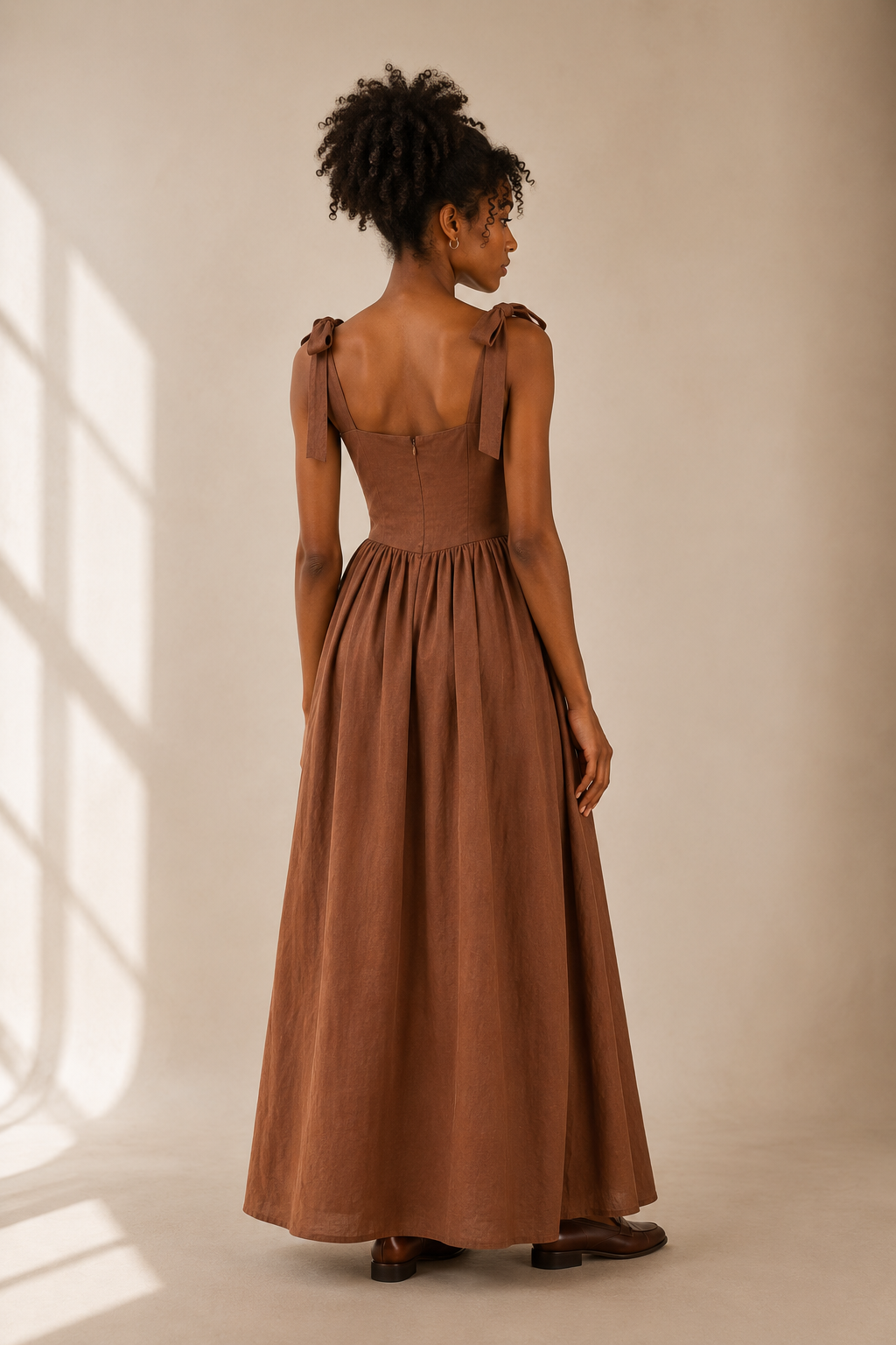 Brown linen a-line maxi dress, back view, fitted bodice and skirt volume