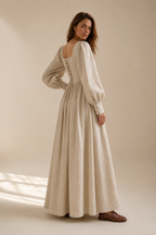 Beige linen a-line maxi dress, three-quarter view, voluminous skirt, tailored top