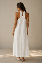White linen shift maxi dress, back view, halter neck and gentle back drape