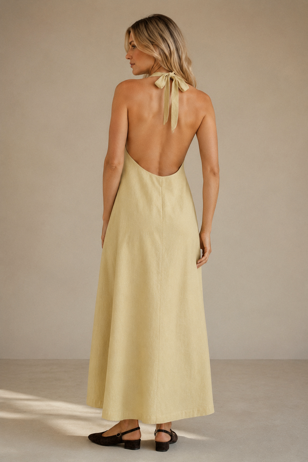 Pale yellow linen shift maxi dress, back view, halter neckline and open back