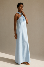 Light blue linen shift maxi dress, three-quarter view, fluid skirt and halter neck detail