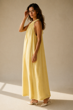 Butter yellow linen shift maxi dress, three-quarter view, flowing linen drape and maxi length