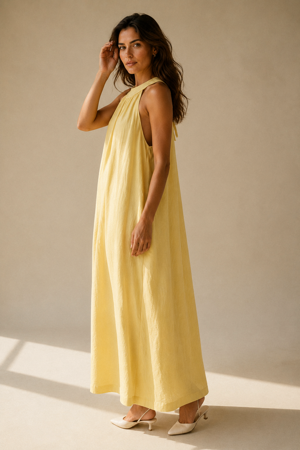 Butter yellow linen shift maxi dress, three-quarter view, flowing linen drape and maxi length
