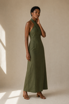 Olive green linen column maxi dress, three-quarter view, flowing maxi length and natural drape