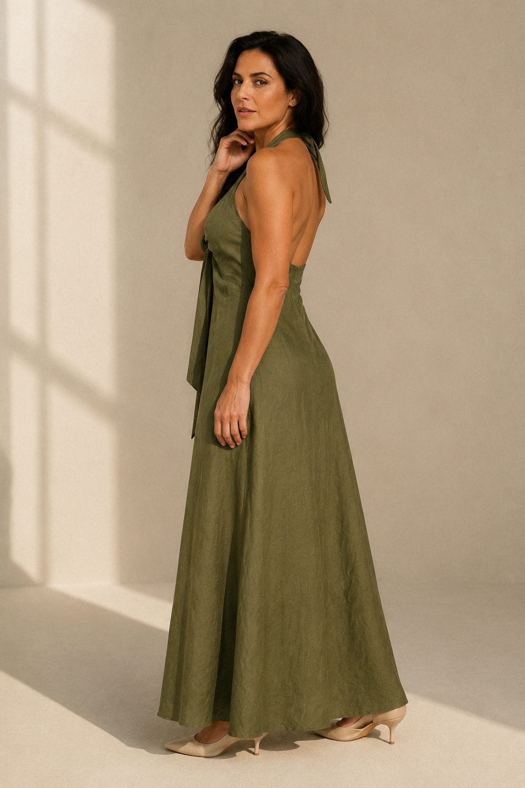 Olive green linen a-line maxi dress, three-quarter view, halter tie and natural fabric drape