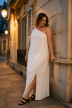 White linen shift maxi dress, front view, one-shoulder design, flowing silhouette, side slit