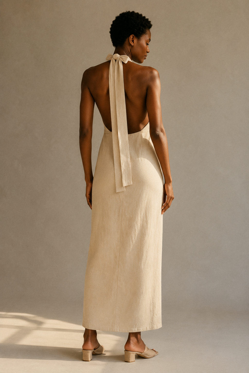 Beige linen column maxi dress, back view, halter tie and open back