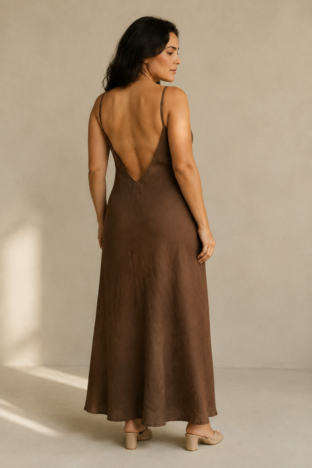 Brown linen slip maxi dress, back view, simple lines, understated elegance
