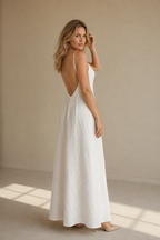 White linen slip maxi dress, three-quarter view, flowing skirt and delicate straps