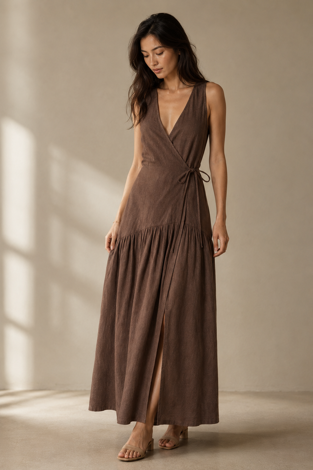Brown linen wrap maxi dress, three-quarter view, adjustable tie waist, flowing silhouette