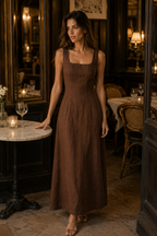 Chocolate brown linen column maxi dress, lifestyle, warm weather ease, natural setting