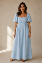 Light blue linen a-line maxi dress, full front view, gathered empire waist, flowing skirt