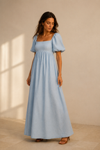 Light blue linen a-line maxi dress, three-quarter view, soft drape, gentle movement, puff sleeves