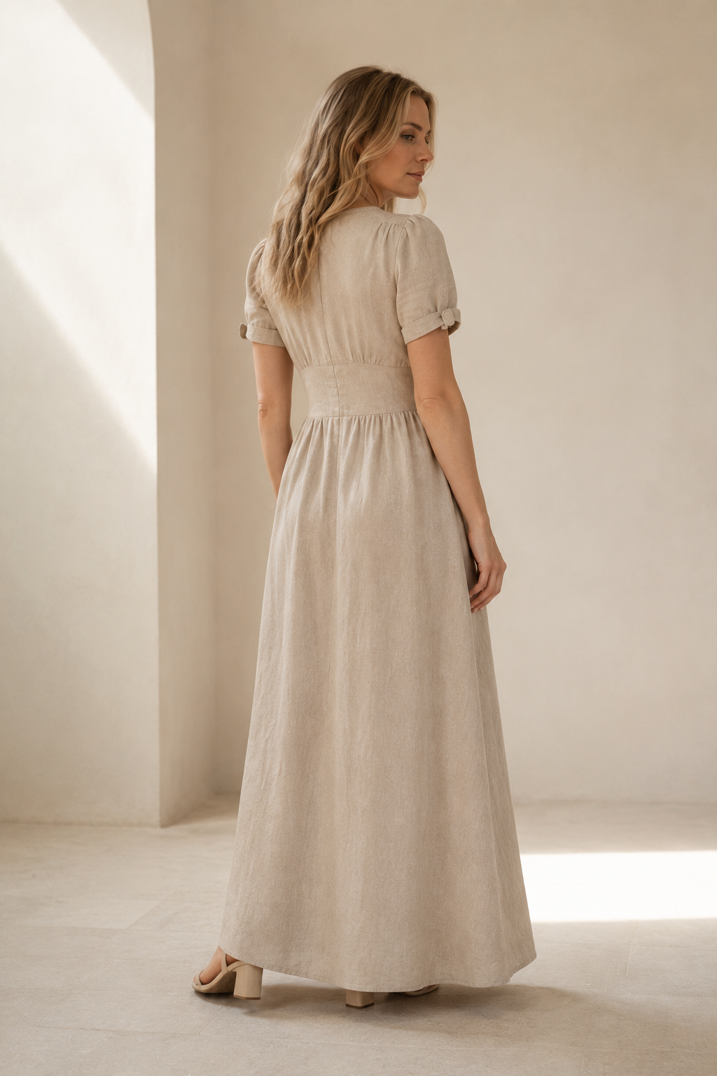 Light beige linen a-line maxi dress, back view, fitted bodice and skirt release
