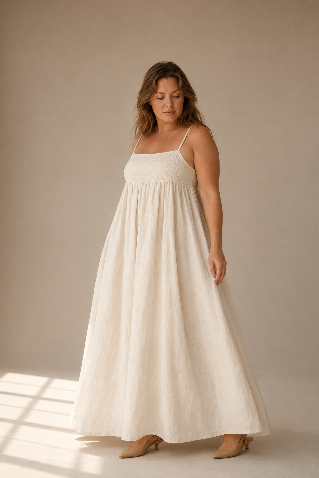 Ivory linen a-line maxi dress, three-quarter view, soft drape of the linen maxi