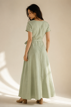 Sage green linen wrap maxi dress, back view, back view of flowing skirt