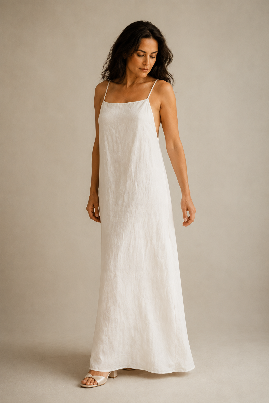 Ivory linen slip maxi dress, three-quarter view, fluid column silhouette