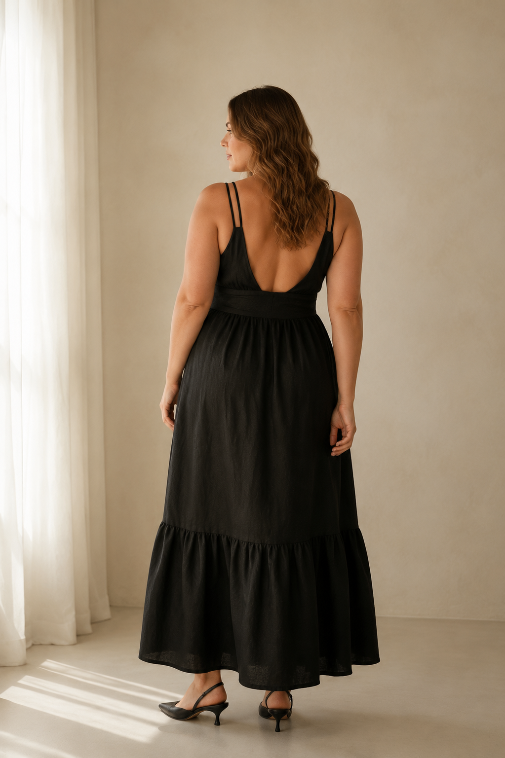 Black linen tiered maxi dress, back view, delicate straps, fluid skirt, relaxed fit