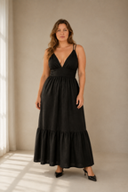 Black linen tiered maxi dress, full front view, fitted bodice, defined waist, flowing tiered skirt