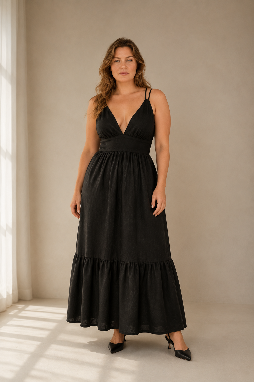 Black linen tiered maxi dress, full front view, fitted bodice, defined waist, flowing tiered skirt