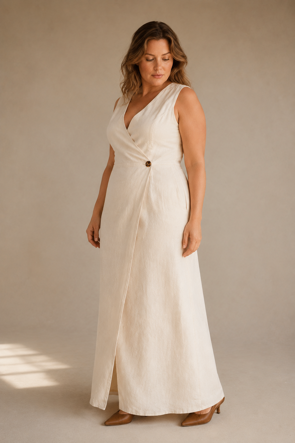 Ivory linen wrap maxi dress, three-quarter view, wrap closure and full skirt drape