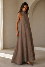 Taupe linen a-line maxi dress, three-quarter view, relaxed fit, gentle skirt movement