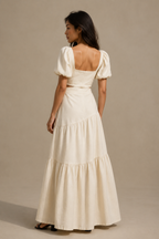 Ivory linen tiered maxi dress, back view, fitted bodice, voluminous tiered skirt