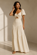 Ivory linen tiered maxi dress, three-quarter view, waist cut-out, tiered skirt movement