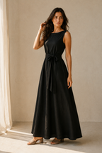 Black linen a-line maxi dress, three-quarter view, flowing skirt, natural waist, boat neck
