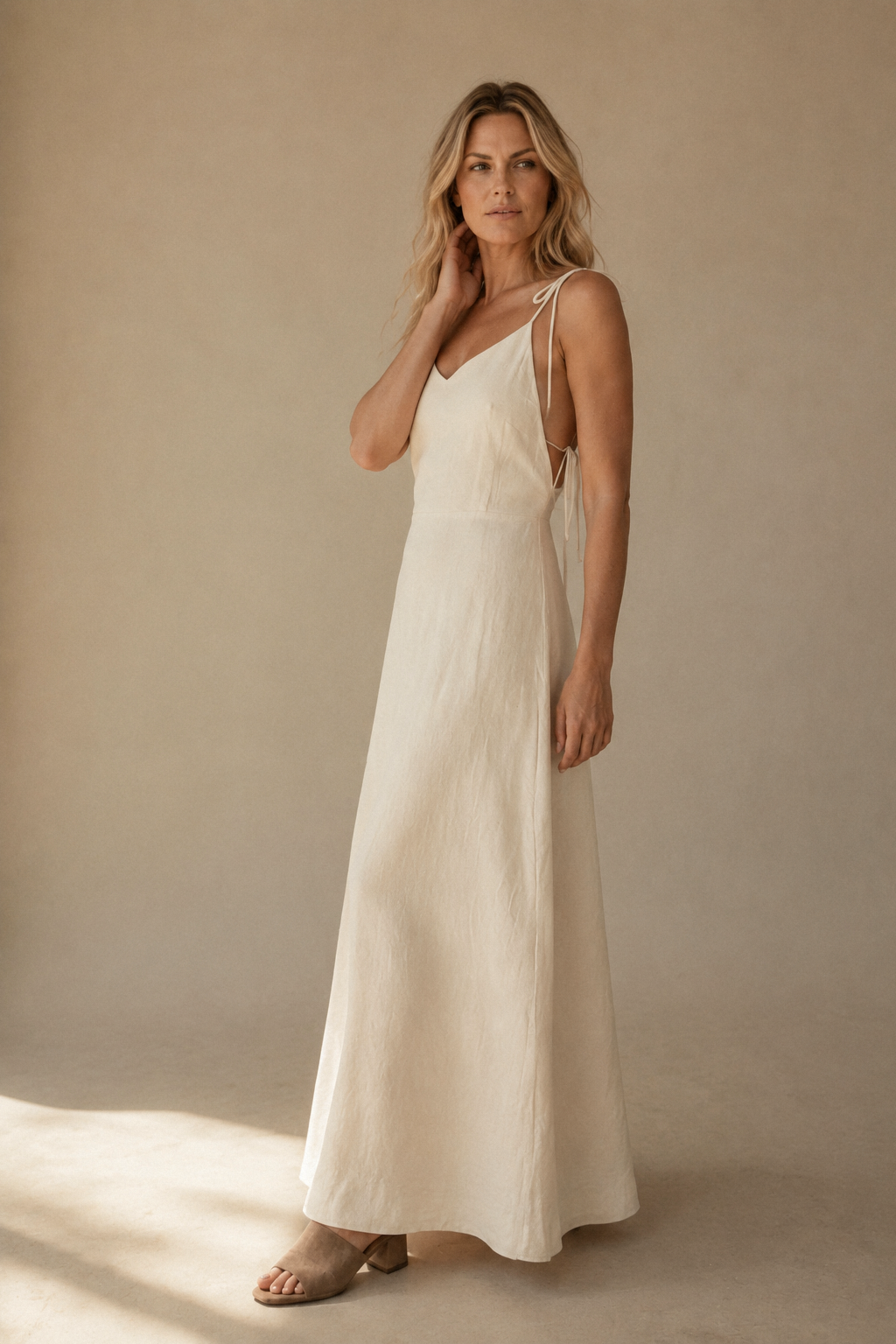 Ivory linen column maxi dress, three-quarter view, flowing skirt and relaxed fit