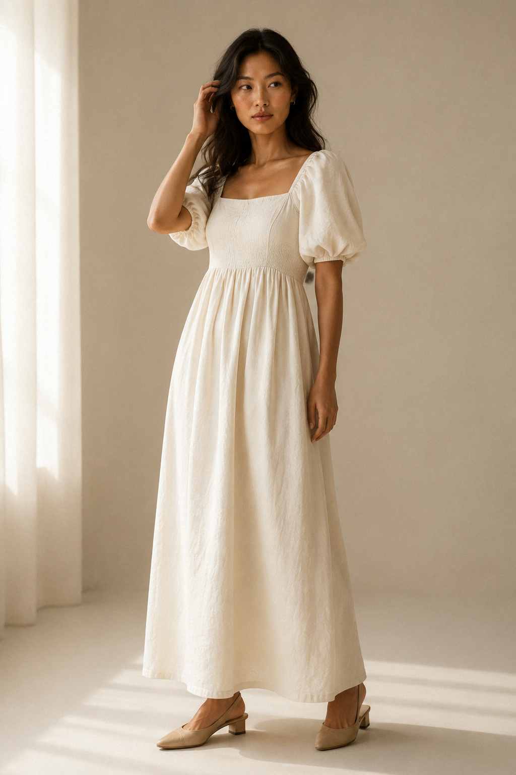 Ivory linen a-line maxi dress, three-quarter view, puff sleeves, gathered waist, relaxed skirt drape