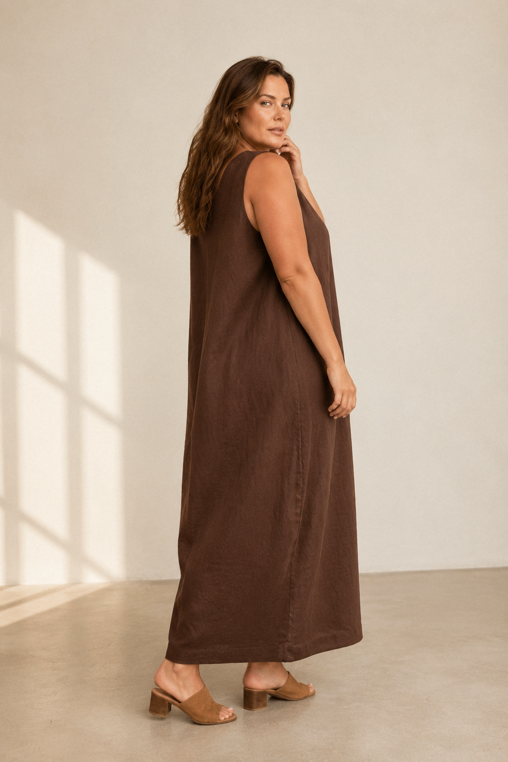 Dark brown linen shift maxi dress, three-quarter view, loose fit and side pockets