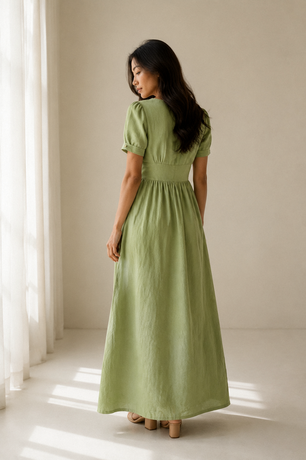 Light green linen a-line maxi dress, back view, gathered waist and flowing skirt