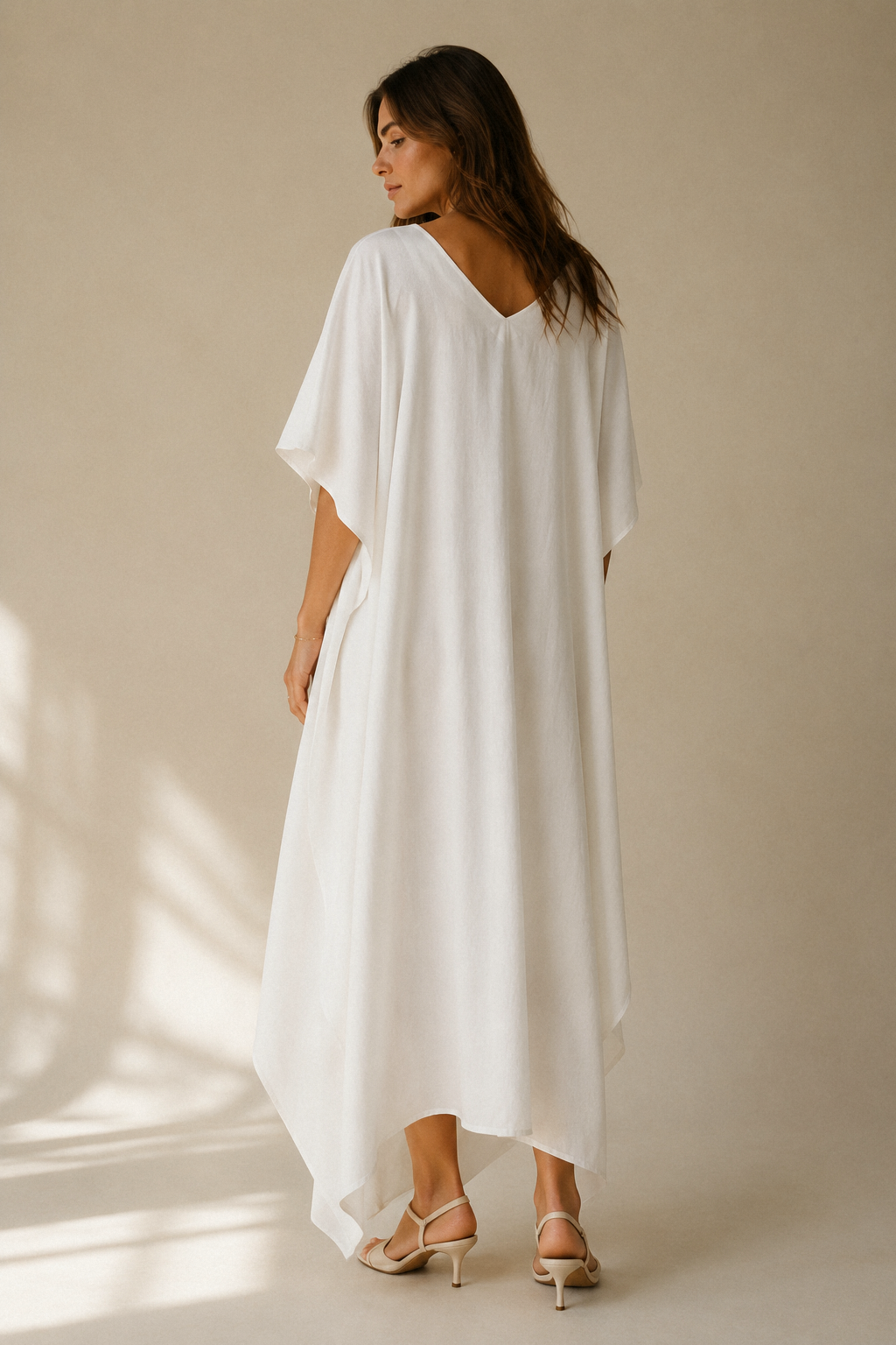White cotton caftan maxi dress, back view, relaxed fit and flowing back